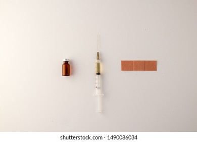 Flat Lay Of Needle, Band Aid, And Vial Of Medicine. Flu Season. Coronavirus