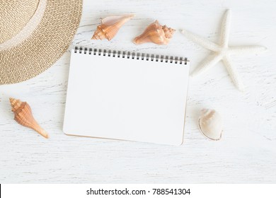 Flat lay notebook with blank and seashell for summer holiday whitewood,Top view from above