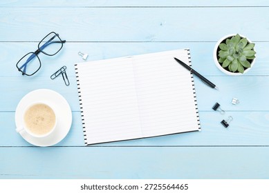 Flat lay with notebook and cup of coffee on wooden background. Office workplace