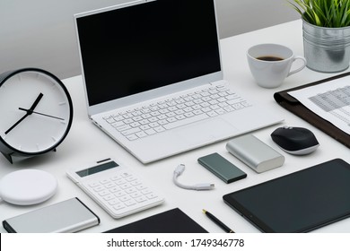 Flat lay of office desktop and gadgets at an angle - Shutterstock ID 1749346778