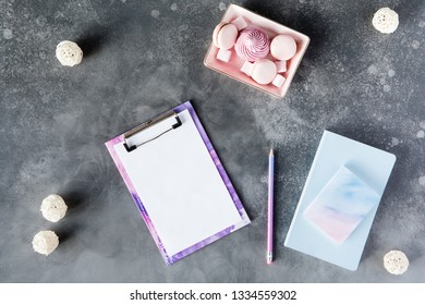 Flat Lay Of Office Stationery With Cup Of Tea With Marshmallow And Laptop On A Gray Background With Shadows. Table Desk With Office Tools, Flatlay And Top View