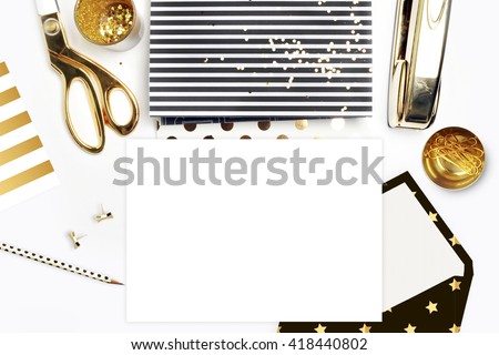 Flat lay, office white desk and envelope with gold stationery. Gold stapler, stripe gold pattern, pencil. View top. Table up. Mock-up background