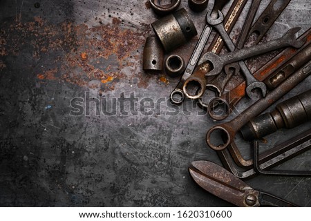 Flat lay Old hand tools ,Pliers screwdriver wrench rusted iron metal tools on Steel plate at garage  
