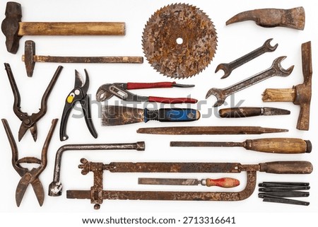 Flat lay of old hand tools on white background. Large collection of various rusty tools and bits arranged on white.