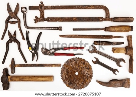 Flat lay of old hand tools on white background. Large collection of various rusty tools and bits arranged on white.