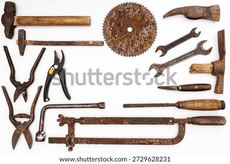 Flat lay of old hand tools on white background. Large collection of various rusty tools and bits arranged on white.