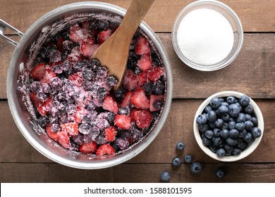 Flat Lay On Berries Mixed With Sugar In A Saucepan, Beside Fresh Blueberries, In Baking Concept