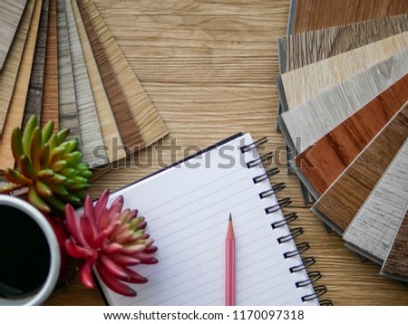 Flat lay on composition space concept , blank book notepad with luxury Vinyl wood flooring sample for interior decoration style