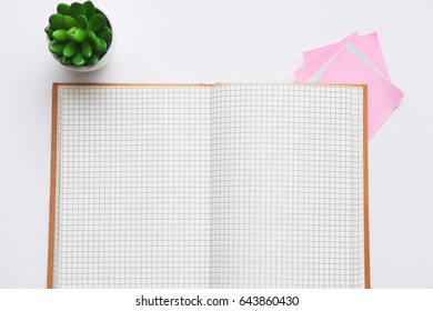 Flat lay open notebook with blank pages on wooden table