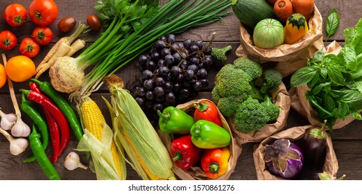 Flat lay of organic fruits and vegetables on wooden background, panorama