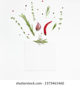 Flat lay overhead view blank notebook pages mockup text space invitation card on white background with greens herbs and spices. Menu or recipe book or food blog design with cooking ingredients