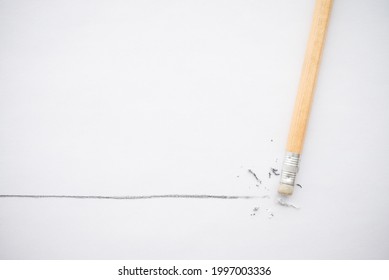 Flat lay of pencil eraser delete black line pencil on white paper background copy space. Repair, remove, creative idea, imagination and education concept.