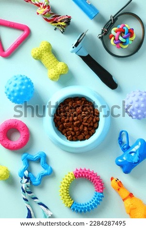 Flat lay pet toys, food and accessories on blue background