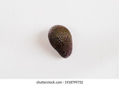 Flat Lay Photo Of An Avocado On White Background