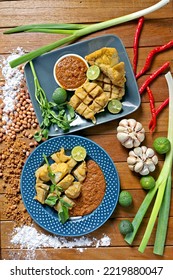 Flat Lay Photo Of Batagor (fish Cake), Indonesia's Signature Street Food Served With Peanut Sauce, Plating In A Wooden Table. 