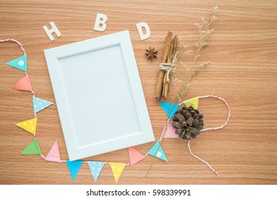 Flat Lay Of Photo Frame With Happy Birthday Wooden Alphabet Mockup On Wooden Table