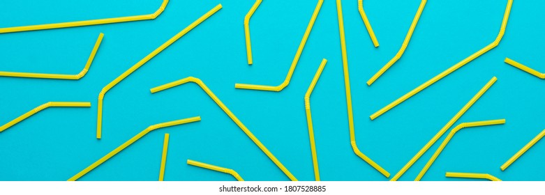 Flat Lay Photo Of Many Yellow Bendy Cocktail Straws. Top View Of Cocktail Straws On Turquoise Blue Background.