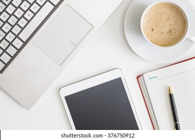 Flat Lay Photo Of Office Desk With Laptop, Tablet, Notebook And Coffee