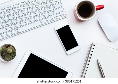 Flat Lay Photo Of Office Desk With Keyboard, Tablet, Smart Phone And Red Cup, Top View 