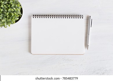 Flat lay photo of office desk on white background,empty notebook open on white wood table - Shutterstock ID 785483779