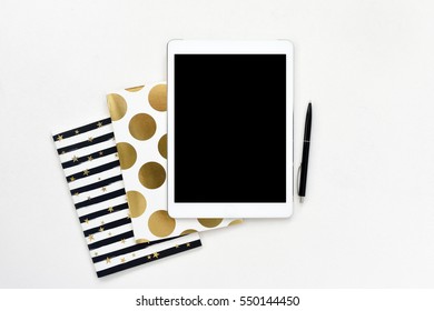 Flat Lay Photo Of Office White Desk With Tablet And Gold Notebook Copy Space Background