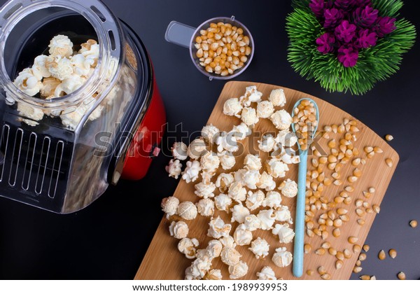flat lay photo of\
popcorn maker and popcorn.