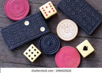 Flat Lay Photo of Vintage Dominoes, Poker Dice, and Checkers on Wood