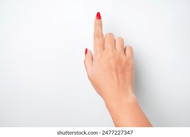 Flat lay photo of A woman's hand with bright red nail polish is making a pointing or touching gesture with the tip of her index finger. Isolated on white background - Cut Out - Powered by Shutterstock