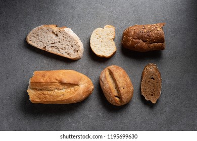 flat lay with pieces of various bread on grey tabletop