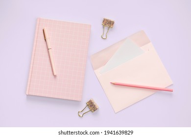 Flat Lay Pink Color Envelope And Stationery On Purple Pastel Floor Background