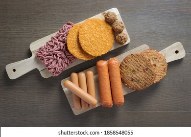 Flat lay of plant based vegetarian meat products for a plant based diet on a wooden table