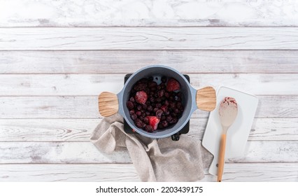 Flat Lay. Preparing Mixed Berry Compote From Frozen Berries In A Nonstick Cooking Pot.