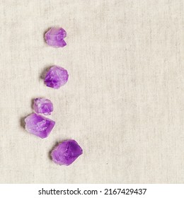 Flat Lay From Purple Amethyst Crystals On Textile Background With Copy Space,  Top View Natural Beautiful Gemstone. Amethyst Stone Healing Crystal, Rocks Quartz Mineral Close Up, Minimal Style 