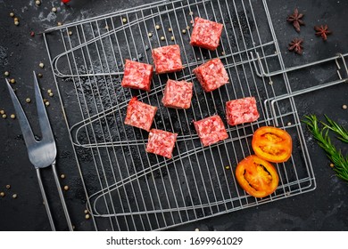 Flat Lay Of Raw Beef Cube Steak On The Grill With Tomato