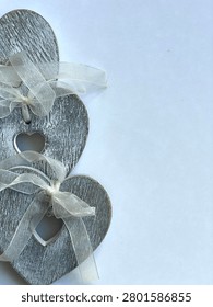 Flat Lay Rustic Grey Rustic Hearts  With White Ribbon On Plain White Background With Negative Space