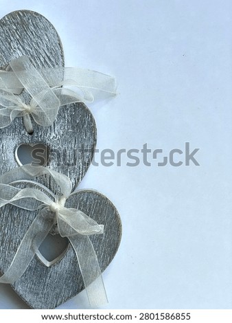Flat Lay Rustic Grey Rustic Hearts  With White Ribbon On Plain White Background With Negative Space