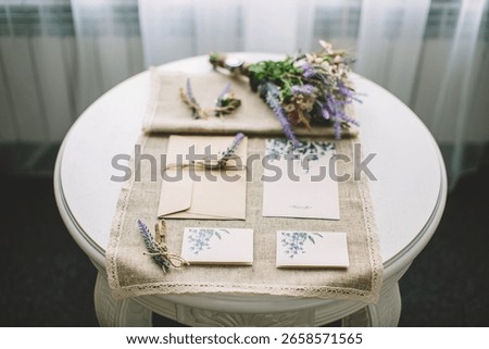Flat lay of rustic wedding invitations, handcrafted floral details, lavender bouquet and envelope on linen cloth, expressing natural elegance, romance, event planning, attention to detail, craftsmansh