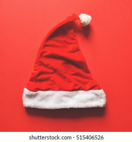 Flat Lay Of Santa Hat On Red Background - Trendy Minimal Flat Lay Design