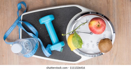 flat lay scale weighs person with water bottle fruit dumbbells and a meter symbol of good hygiene of life to lose weight in top view - Powered by Shutterstock