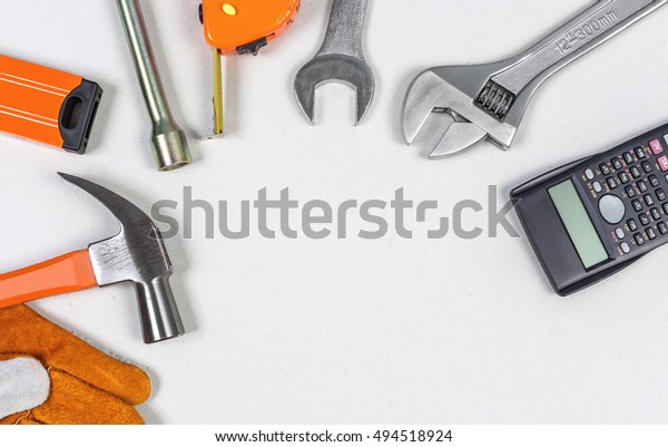 Flat lay of set Mechanic Tools\
of car repairing on grey paper background, top view\
shot.