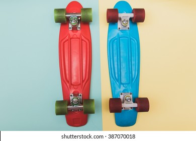 Flat lay set : red and blue skateboards on yellow and light-blue pastel background - Powered by Shutterstock