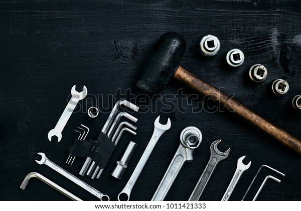 Flat lay of set of tools for
car repairing such as wrenches on black wooden background. Top
view.