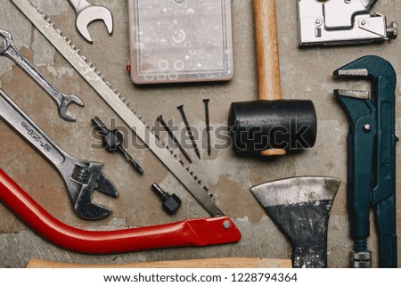 Flat lay with set of tools and smartphone on wooden background