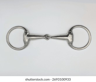 Flat Lay Of Single Eggbutt Flat Ring Snaffle Horse Bit On White Background