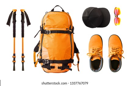 Flat lay of sport equipment and clothes for hiking and trekking. Top view of walking poles, backpack, boots, etc. isolated on white background