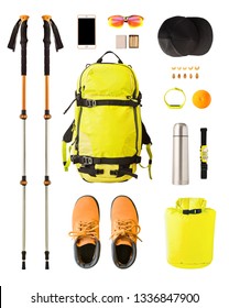 Flat Lay Of Sport Equipment And Gear For Hiking And Trekking. Top View Of Walking Poles, Backpack, Food, Boots, Etc. Isolated On White Background