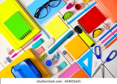 Flat lay of stationery on white wooden table background - Shutterstock ID 454031641