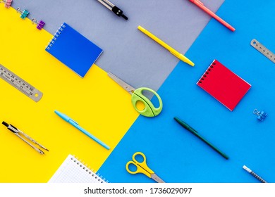 Flat lay stationery set - notebook, pen, sciccors - on colorful background top view