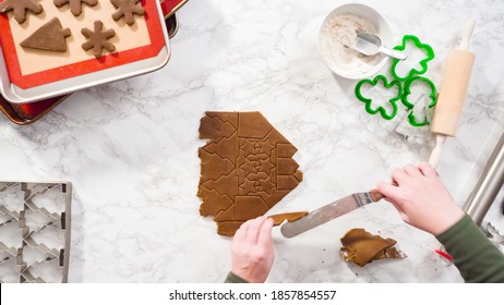 Flat lay. Step by step. Cutting out shapes with Christmas cookies cutter from gingerbread cookie dough.