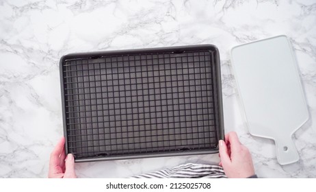 Flat Lay. Step By Step. Empty Cookie Tray With Drying Rack On A Marble Kitchen Surface.